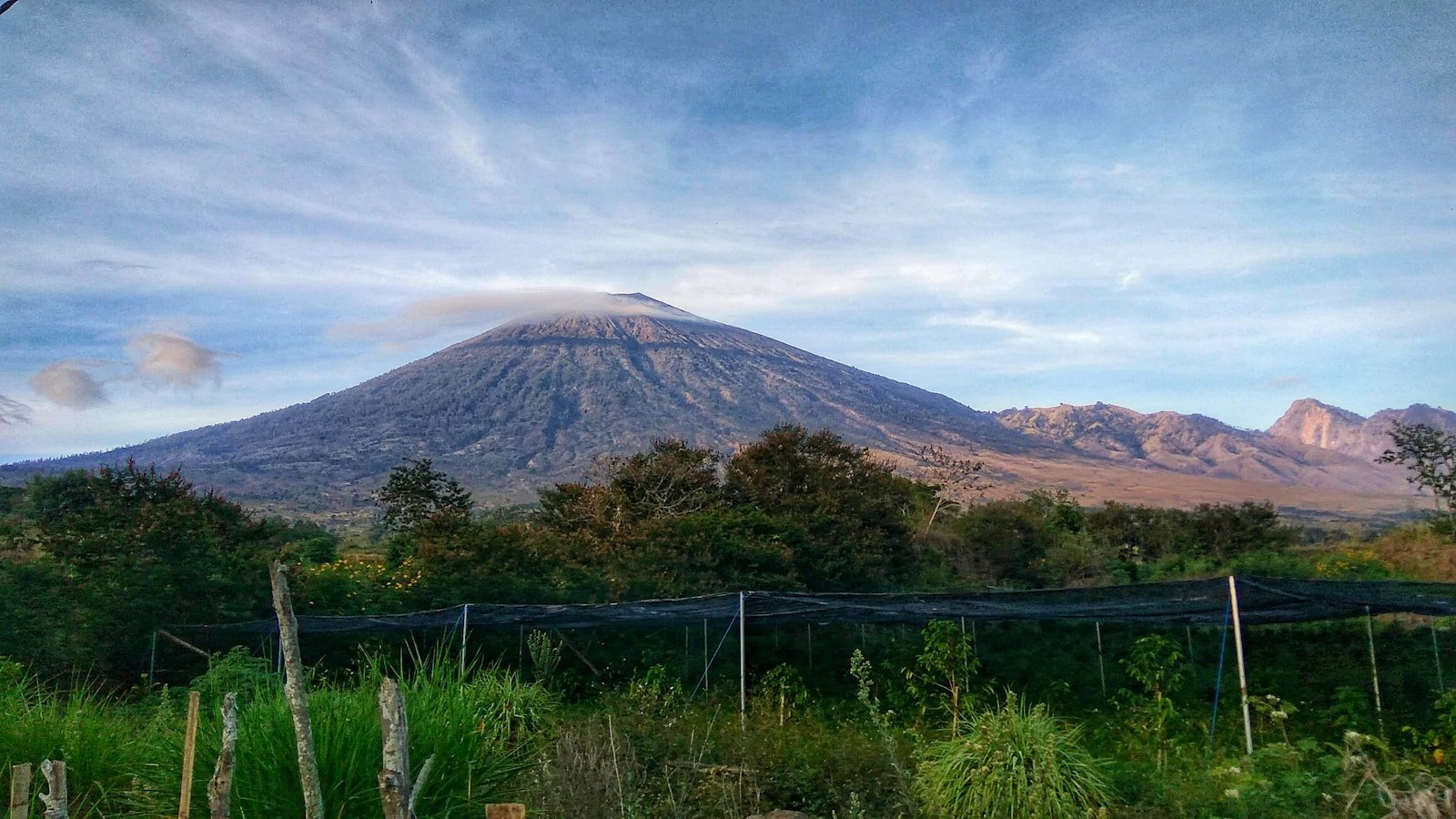 A view of a mountain with a fence in front of it